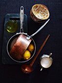 Still life with copper casserole and lemons
