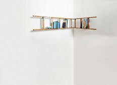 L-shaped bookshelf made from ladders running around corner