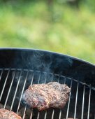 A hamburger on a barbecue