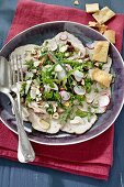 Veal carpaccio with radishes, rocket and hazelnuts