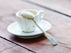 An empty espresso cup with a spoon