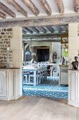 View from dining room into country-house kitchen with blue and white ornamental floor tiles