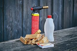 Chunks of wood, a fire lighter and lighting fluid