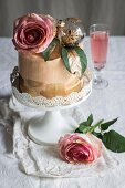 Chiffon cake with roses and sparkling rosé wine for Christmas