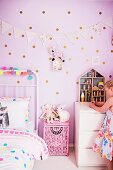 Girl in pink children's room with dotted wall