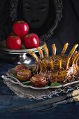 A crown of pork ribs with raisin-filled apples for Halloween