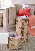 A stump of birch wood as a side table with the tops painted pink