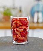 A glass of sliced strawberries
