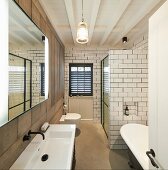 Shower cabinet and free-standing bathtub in narrow, purist bathroom
