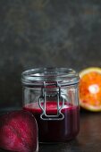 Beetroot juice with blood orange in a flip-top jar