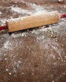 A wooden rolling pin dusted with flour