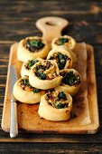Pastries filled with spinach, ricotta and pine nuts