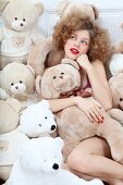 A young woman covered in teddy bears