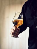 A man holding a glass of India Pale Ale