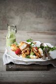 Crumbed buchette, harissa-grilled chicken and barley salad with a creamy basil dressing