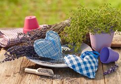 Hand-made, heart-shaped lavender sachets on table outdoors