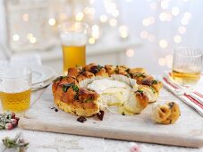 A bread wreath with baked Camembert for Christmas