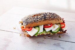 Sesame and poppy seed roll with camembert, vegetables and lettuce