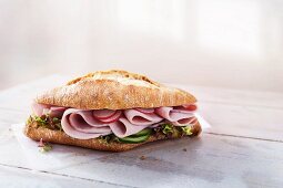 Ciabatta roll with ham, radishes, cucumber and lettuce