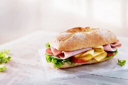 Baguette with ham, cheese, vegetables and lettuce