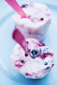Homemade blueberry ice cream with plastic spoons