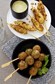Chicken satay with peanut sauce and chicken meatballs kebabs with coriander (Asia)