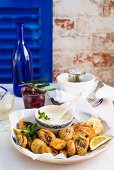 Fried herbs and tomatoes with tzatziki