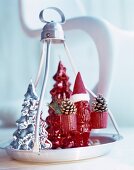 Red gnome ornament wearing Father Christmas hat on festively decorated tray