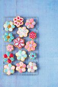 Flower-shaped carrot cookies with colourful sugar glaze