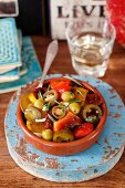 Grilled peppers with dried tomatoes, olives and jalapeños