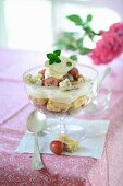 A trifle with red gooseberries and homemade almond biscuits