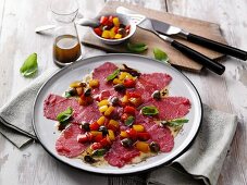 Beef carpaccio with a peperonata dressing and moringa powder