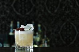 A Whiskey Sour cocktail on a bar