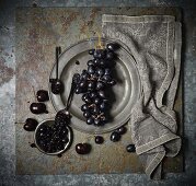 An arrangement of grapes, black cherries and cherry jam