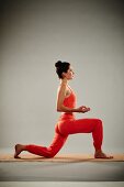Sun salutation - Step 6: kneel on your left knee and touch your thumbs to your index finger