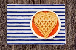 Waffle heart on an orange plate