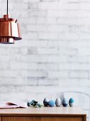 Blue coloured Easter eggs on wooden table