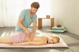 A man massaging a woman's back