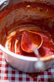 A pot with remnants of tomato sauce