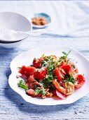 Sweet and sour watermelon salad with pink grapefruit and prawns