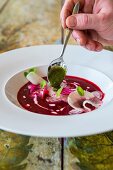 Beetroot soup with apple, goat's kefir and bishopsweed pesto