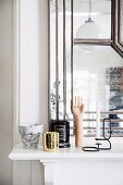 Marble pot and various vessels on mantelpiece