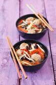 Broth with pork meatballs, Mu-Err mushrooms, bamboo shoots, rice noodles and peppers