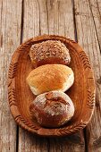 A rye bread roll, a wheat bread roll and a wholemeal roll