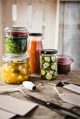 A selection of jars with pesto, ketchup, piccalilli, chutney and gherkins