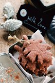 Gluten-free leaf shaped chocolate biscuits to be hung up as decorations