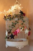 Original, festive arrangement of birdcage and decorations