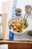 Chicken stir-fry with vegetables, pineapple, ginger and chilli on rice (Asia)
