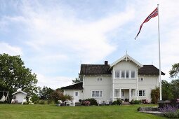 Country villa with Norwegian flag on flagpole