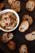 An aubergine dip with pomegranate seeds and grilled bread